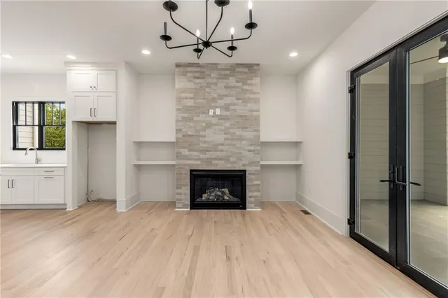 a large kitchen with stainless steel appliances a large counter top a stove and a refrigerator