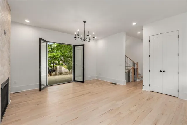 a view of an empty room window and wooden floor