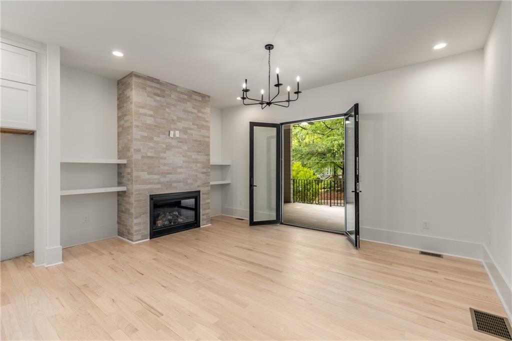 628 Robinson Avenue Southeast, Unit B Atlanta, GA 30312 - Photo 16 of 77 a view of an empty room with a fireplace and a window