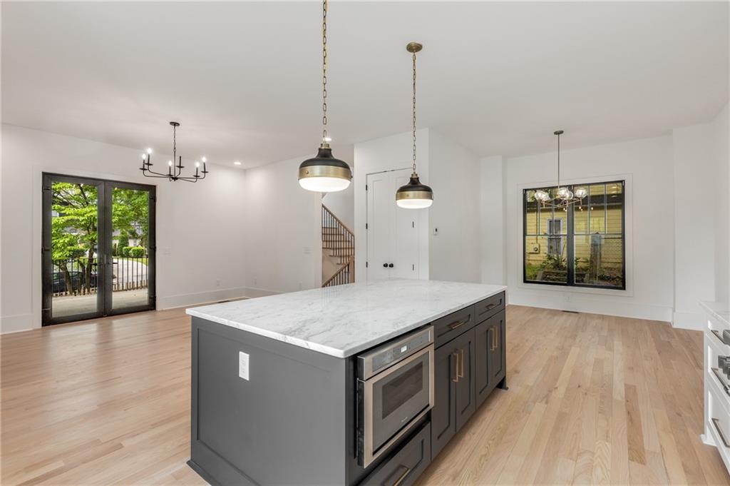 628 Robinson Avenue Southeast, Unit B Atlanta, GA 30312 - Photo 17 of 77 a kitchen that has a sink a window and a wooden floor