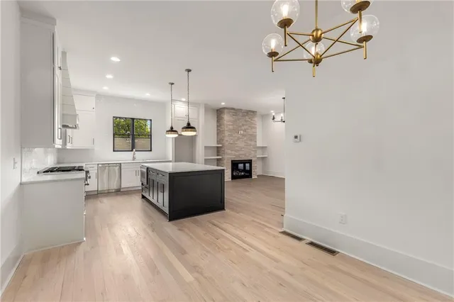 a view of a hallway with wooden floor and closet area