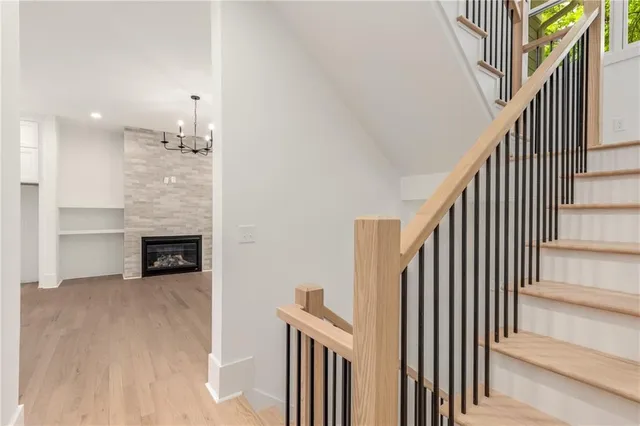 a view of empty room with wooden floor and ceiling fan