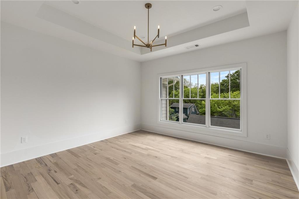 628 Robinson Avenue Southeast, Unit B Atlanta, GA 30312 - Photo 30 of 77 a view of an empty room with wooden floor closet and a window