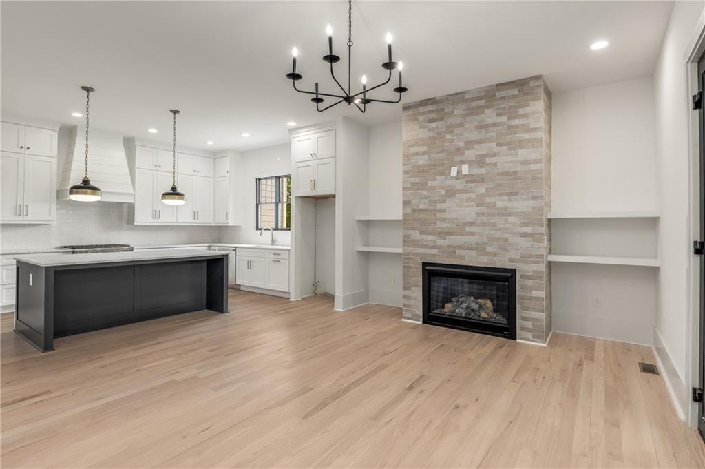 628 Robinson Avenue Southeast, Unit B Atlanta, GA 30312 - Photo 3 of 77 a kitchen with kitchen island a sink stainless steel appliances and a fireplace