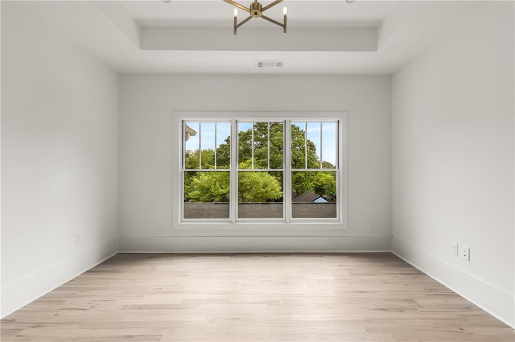 628 Robinson Avenue Southeast, Unit B Atlanta, GA 30312 - Photo 33 of 77 an empty room with a window and a ceiling fan