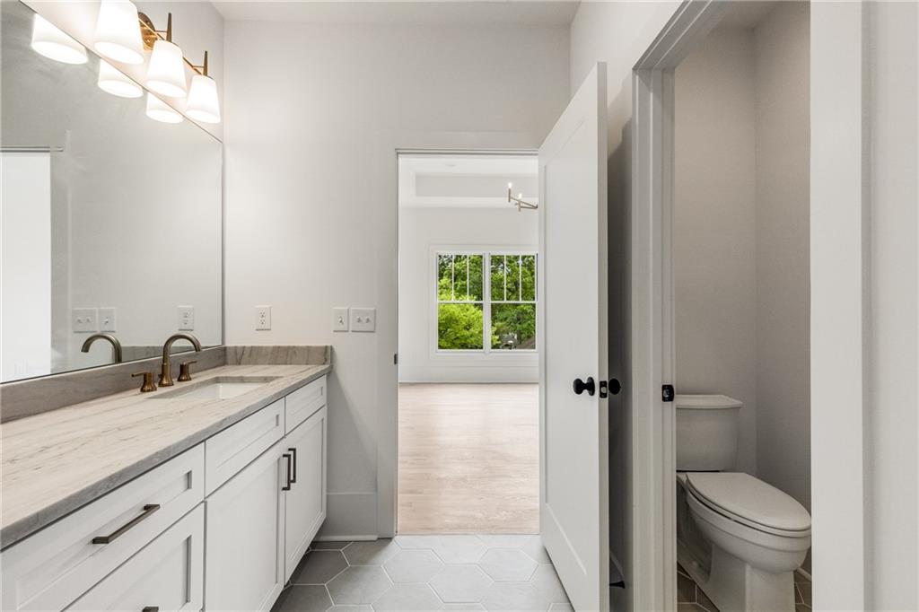 628 Robinson Avenue Southeast, Unit B Atlanta, GA 30312 - Photo 36 of 77 a bathroom with a granite countertop sink toilet and shower