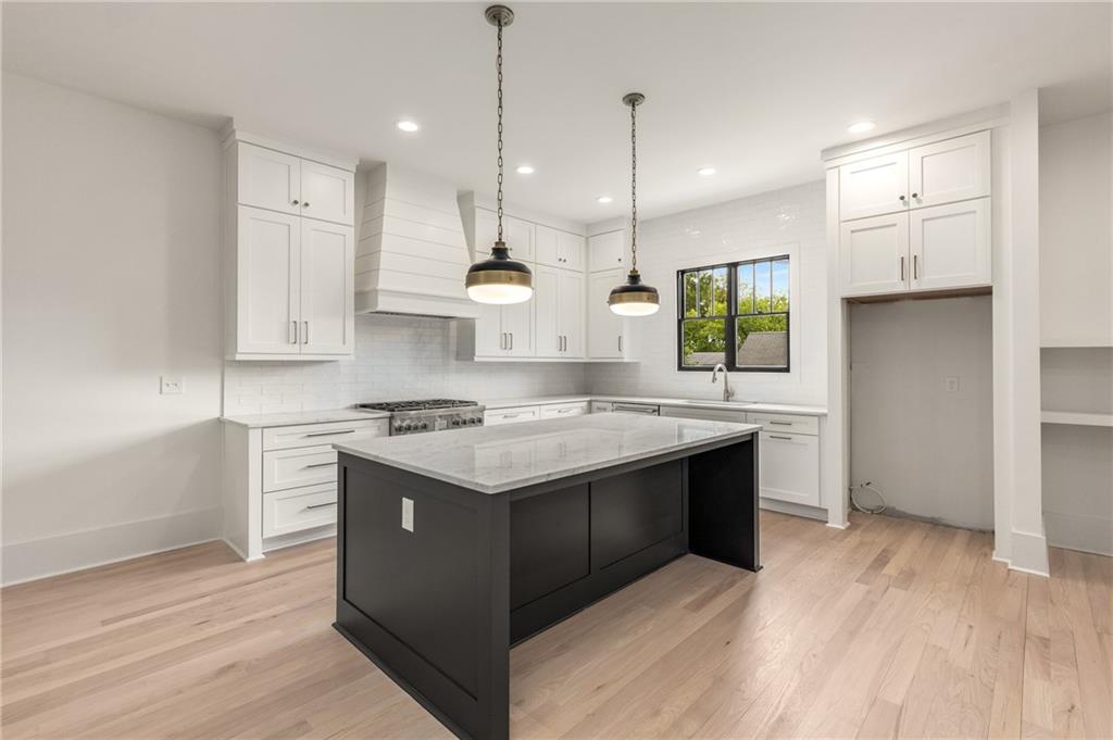 628 Robinson Avenue Southeast, Unit B Atlanta, GA 30312 - Photo 7 of 77 a kitchen with stainless steel appliances granite countertop a sink a stove and a wooden floors