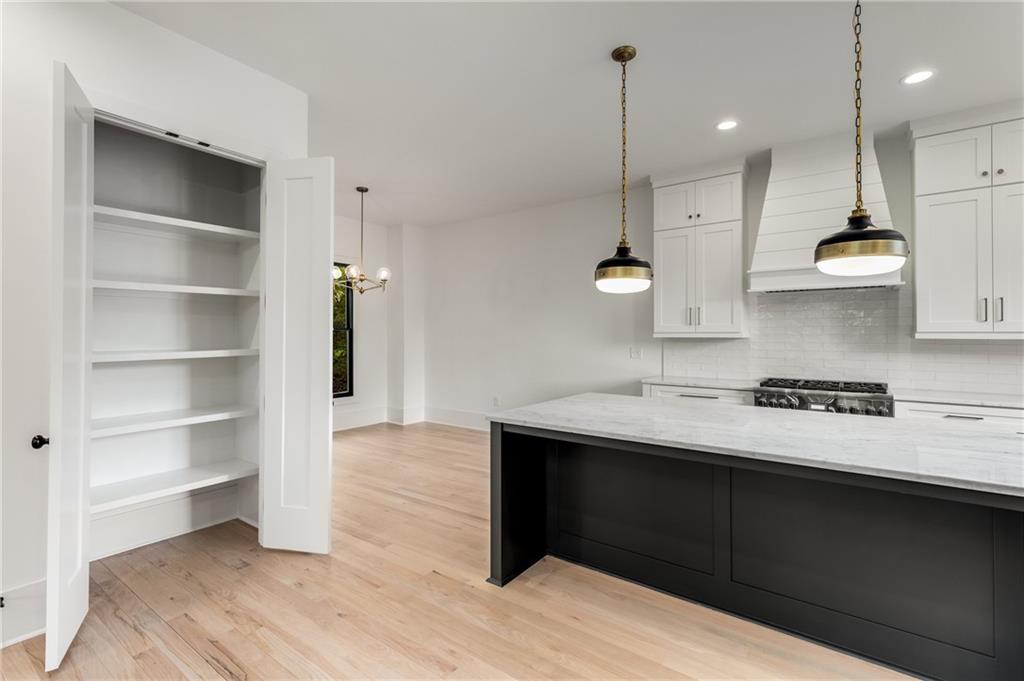 628 Robinson Avenue Southeast, Unit B Atlanta, GA 30312 - Photo 8 of 77 a kitchen with stainless steel appliances granite countertop a sink a stove and a wooden floors