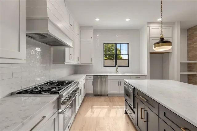 a view of an empty room with a fireplace and a window
