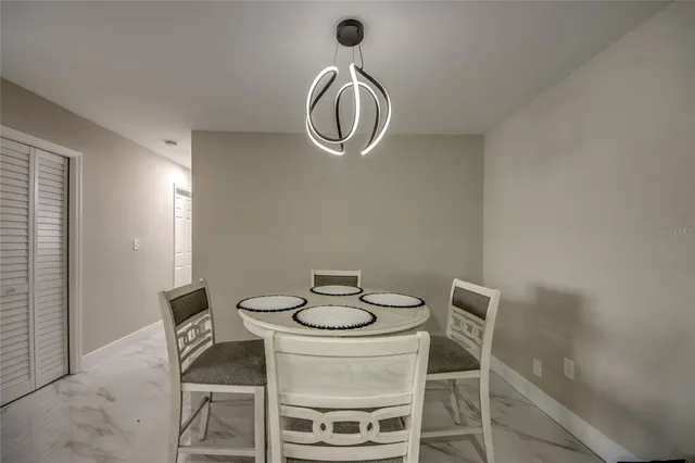 a dining room with table chairs and wooden floor