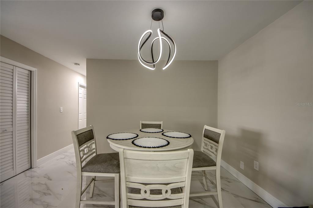 2544 First Street, Unit 107 Fort Myers, FL 33901 - Photo 12 of 35 a dining room with table chairs and wooden floor