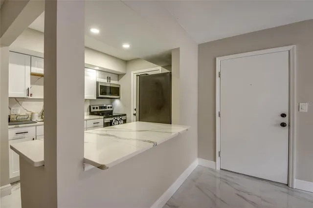 a large bathroom with a large mirror vanity and shower