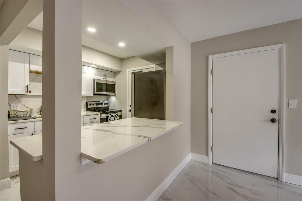 2544 First Street, Unit 107 Fort Myers, FL 33901 - Photo 16 of 35 a large bathroom with a large mirror vanity and shower