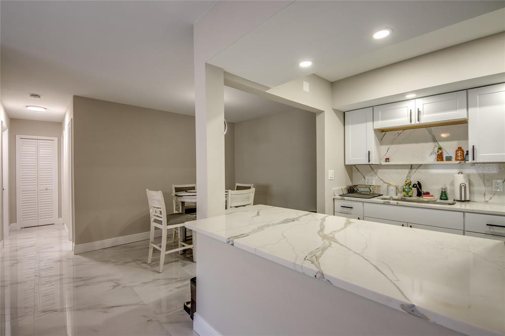 2544 First Street, Unit 107 Fort Myers, FL 33901 - Photo 18 of 35 a room with a bed and a view of kitchen