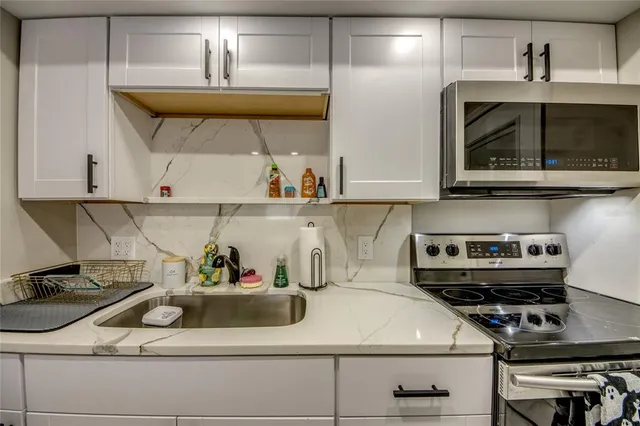 a kitchen with a stove and cabinets