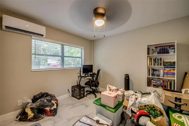 a view of a workspace with furniture and a window