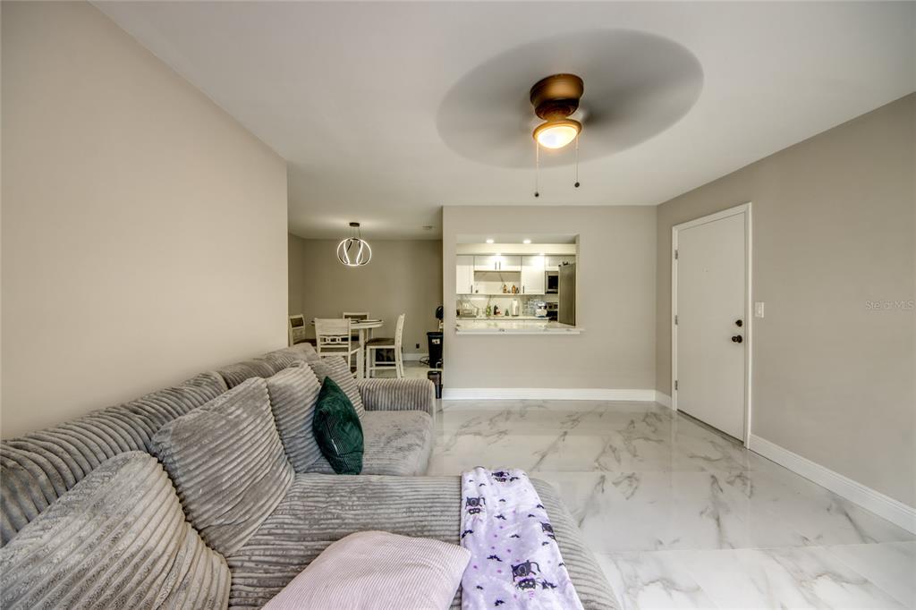 2544 First Street, Unit 107 Fort Myers, FL 33901 - Photo 10 of 35 a living room with furniture and a chandelier