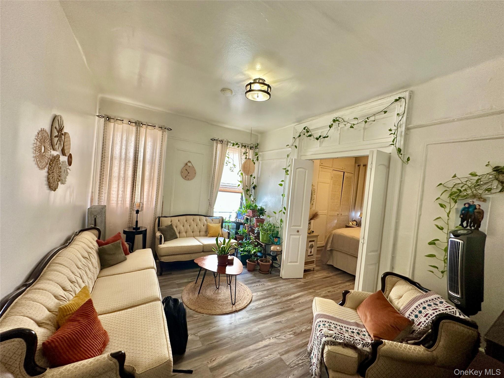 543 West 160th Street, Unit 5D Manhattan, NY 10032 - Photo 3 of 13 a living room with furniture and a chandelier