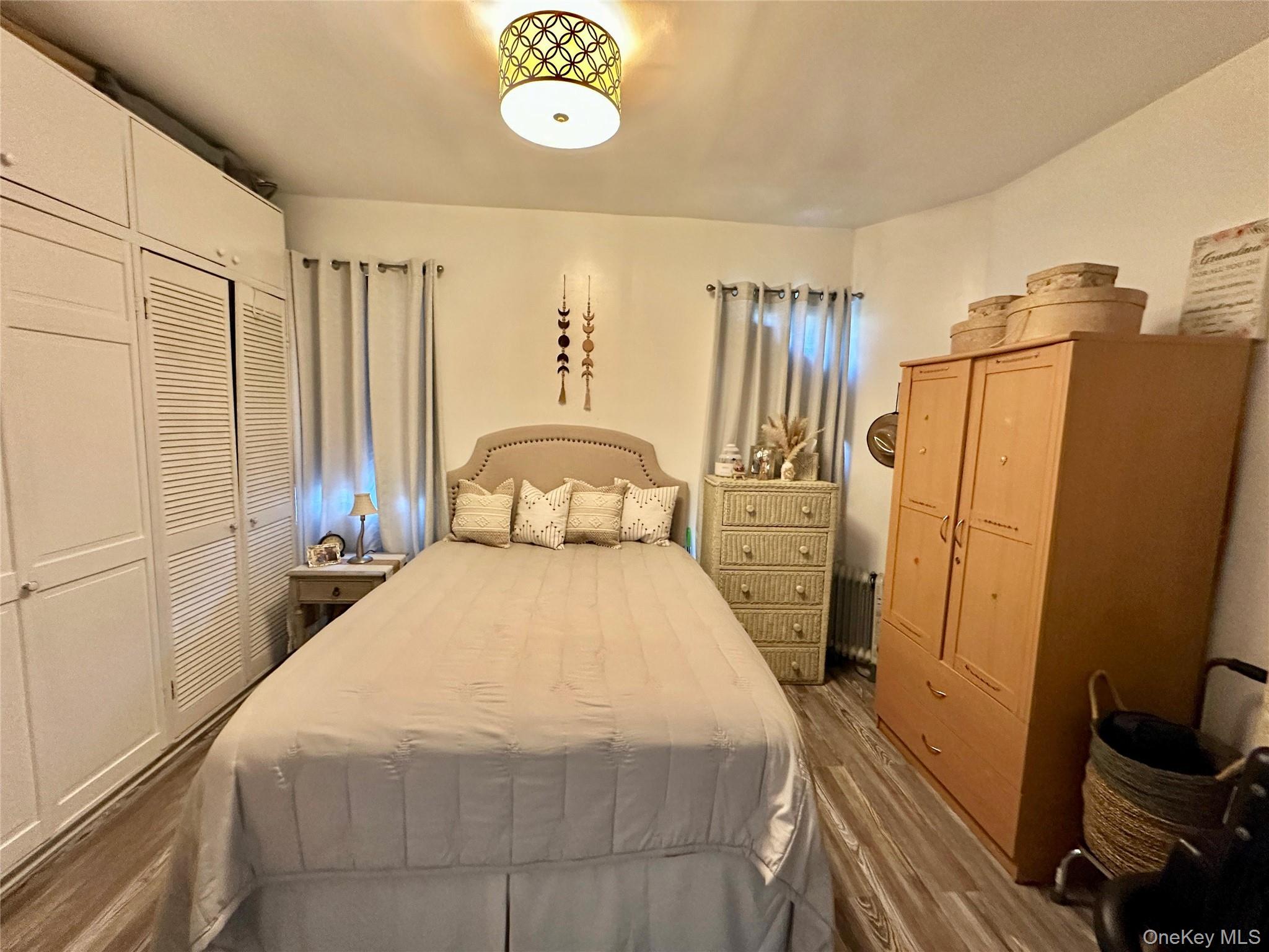 543 West 160th Street, Unit 5D Manhattan, NY 10032 - Photo 5 of 13 a bedroom with a bed and a mirror