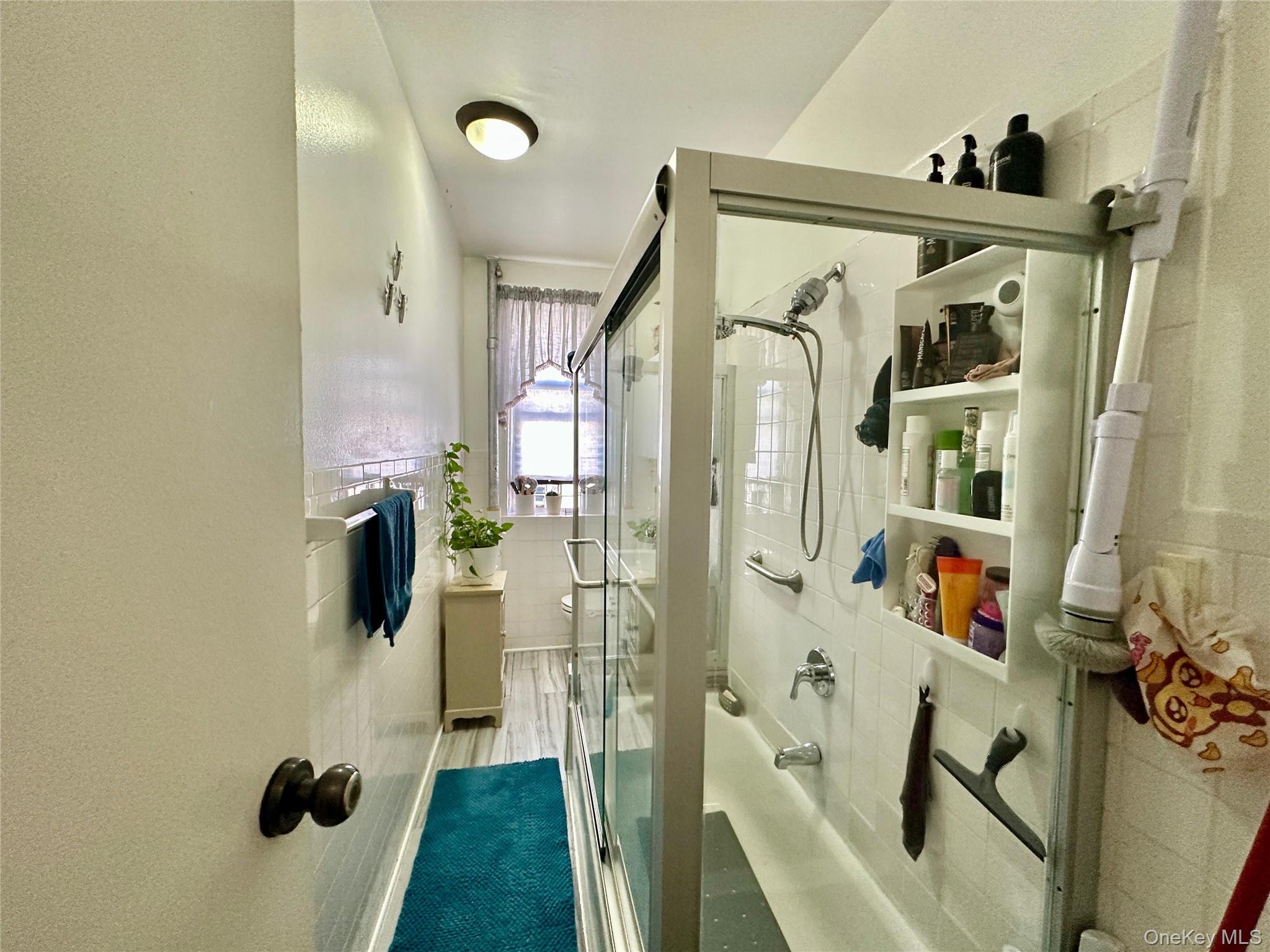 543 West 160th Street, Unit 5D Manhattan, NY 10032 - Photo 10 of 13 a bathroom with a tub and shower