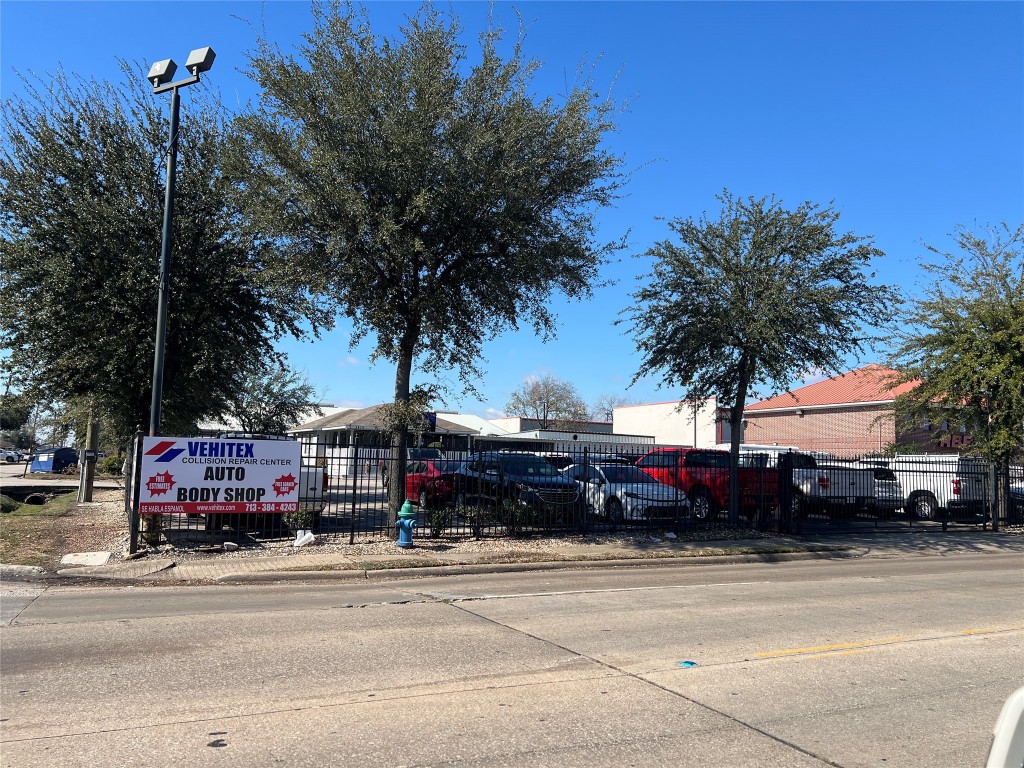a front view of a building with trees around