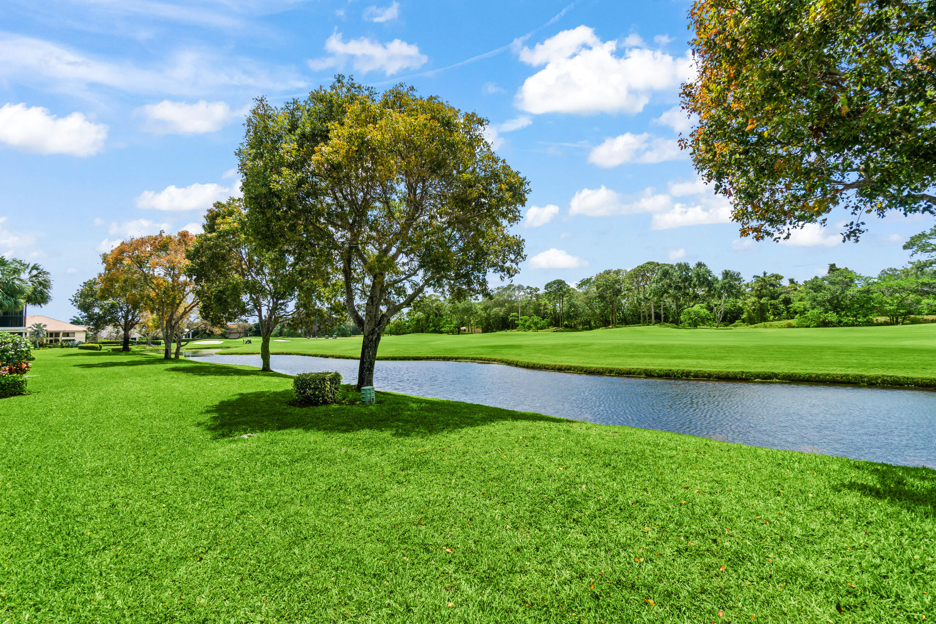17629 Ashbourne Lane, Unit A Boca Raton, FL 33496 - Photo 33 of 35 a view of a golf course with a lake
