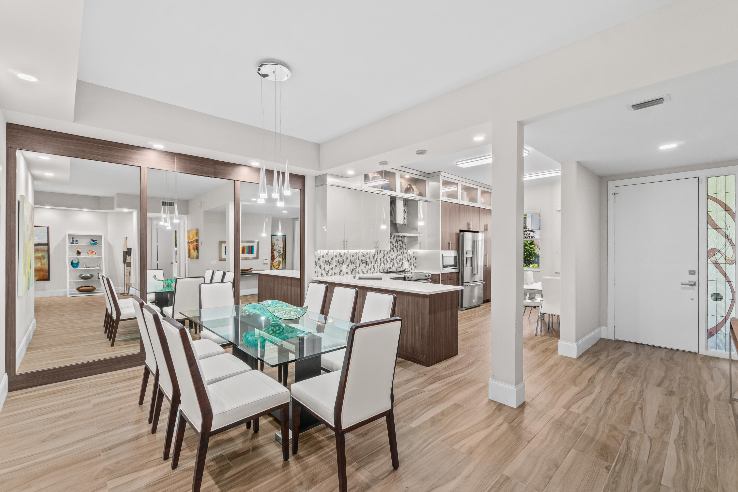 17629 Ashbourne Lane, Unit A Boca Raton, FL 33496 - Photo 7 of 35 a kitchen with a table and chairs