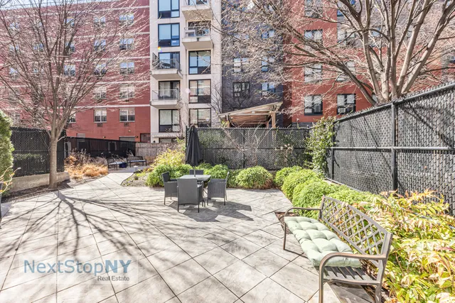 a view of a patio with table and chairs and potted plants