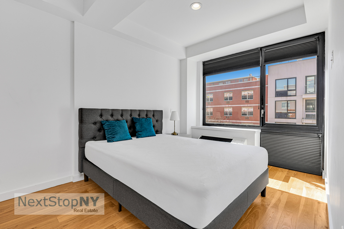48 East 132nd Street, Unit 5C Manhattan, NY 10037 - Photo 5 of 10 a bedroom with a bed and a large window