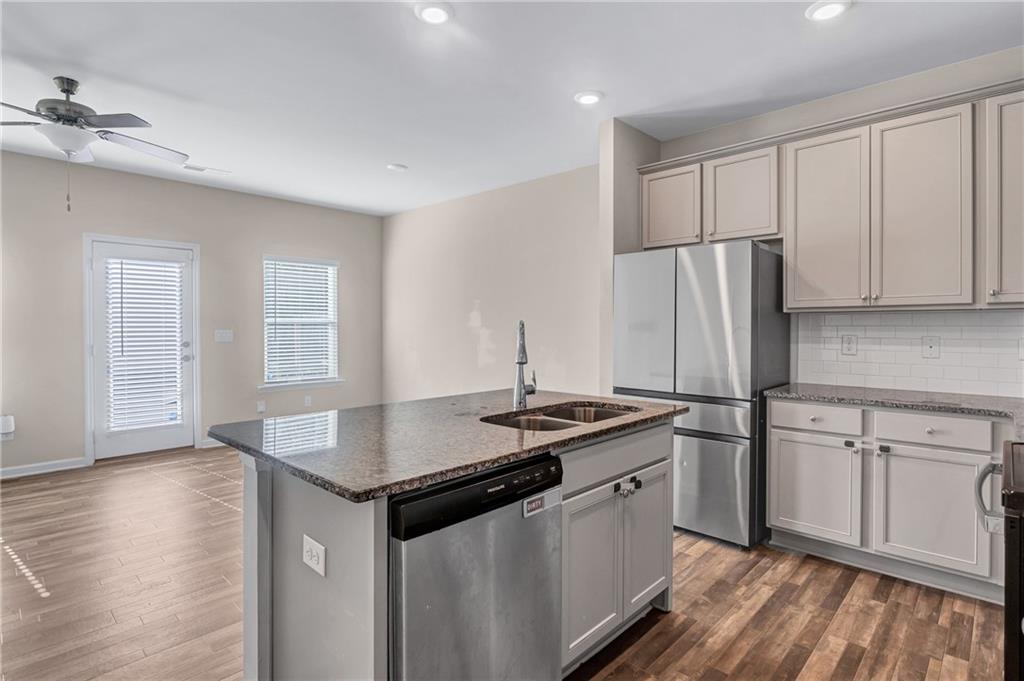 585 McWilliams Road Southeast, Unit 903 Atlanta, GA 30315 - Photo 12 of 37 a kitchen with stainless steel appliances granite countertop a sink stove and refrigerator
