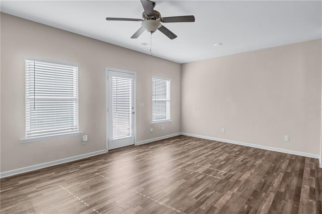 585 McWilliams Road Southeast, Unit 903 Atlanta, GA 30315 - Photo 13 of 37 a view of an empty room with a window and wooden floor