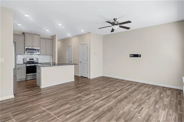 a view of kitchen with granite countertop cabinets and refrigerator