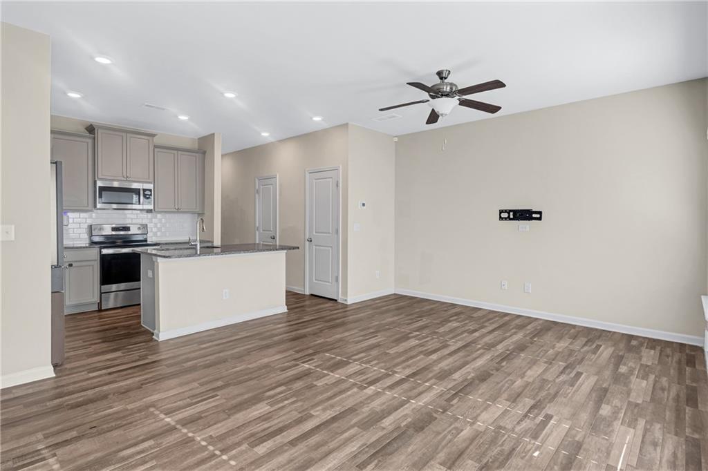 585 McWilliams Road Southeast, Unit 903 Atlanta, GA 30315 - Photo 14 of 37 a view of a kitchen with a sink and dishwasher a refrigerator with wooden floor
