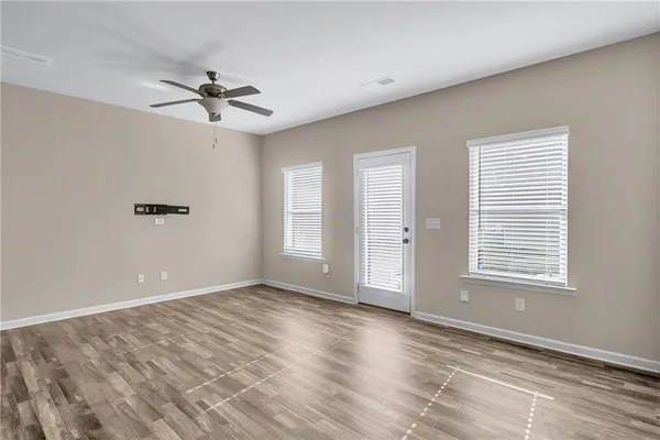a kitchen with a refrigerator and white cabinets