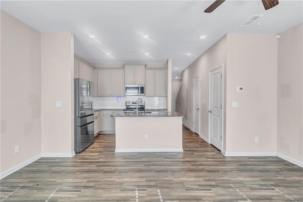 585 McWilliams Road Southeast, Unit 903 Atlanta, GA 30315 - Photo 17 of 37 a kitchen with a refrigerator and white cabinets