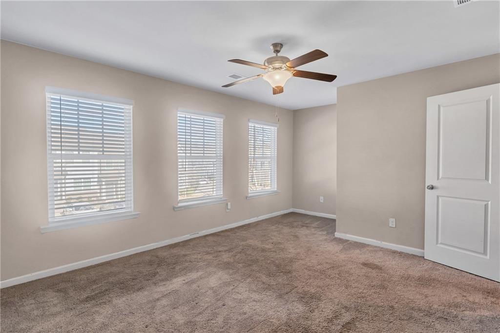 585 McWilliams Road Southeast, Unit 903 Atlanta, GA 30315 - Photo 21 of 37 a view of an empty room with chandelier fan and a window