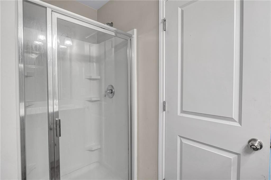 585 McWilliams Road Southeast, Unit 903 Atlanta, GA 30315 - Photo 26 of 37 a bathroom with a glass shower door