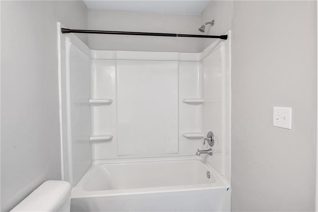 585 McWilliams Road Southeast, Unit 903 Atlanta, GA 30315 - Photo 33 of 37 a white bath tub with shower