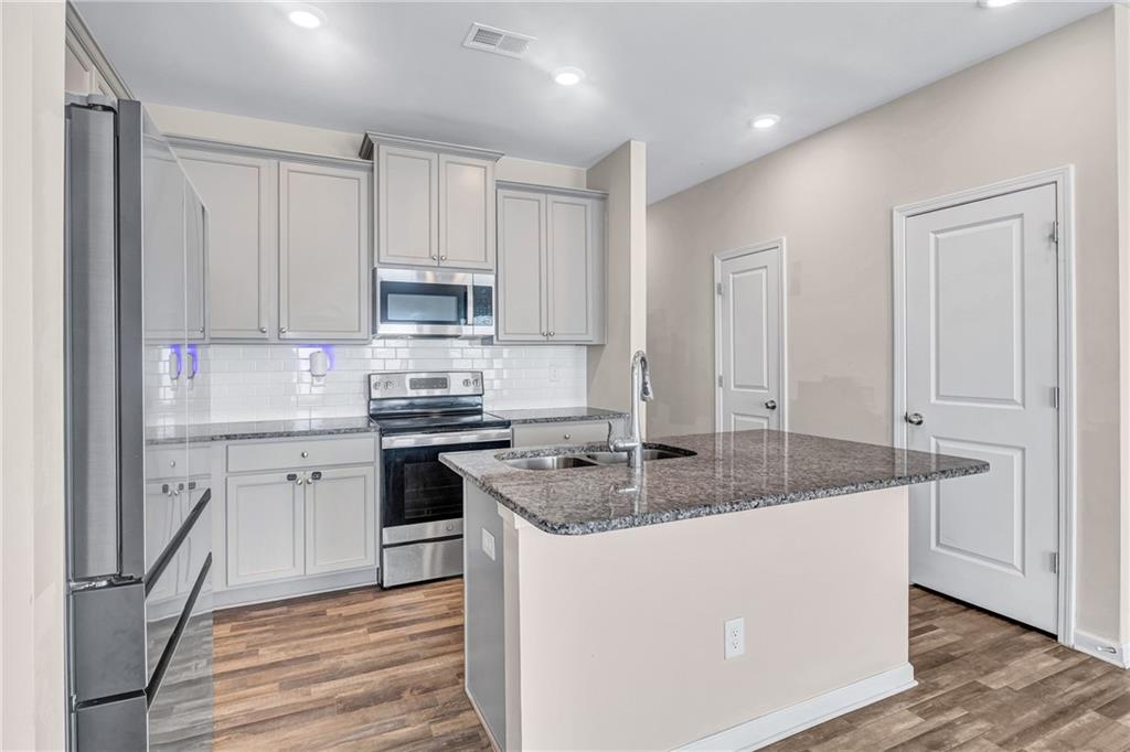 585 McWilliams Road Southeast, Unit 903 Atlanta, GA 30315 - Photo 10 of 37 a kitchen with cabinets appliances a sink and a counter top space