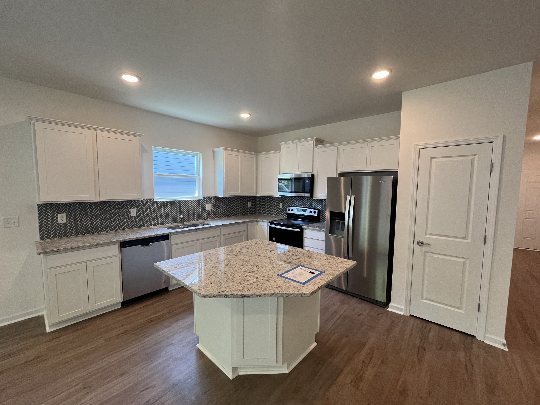 3547 Peace Road Columbia, TN 38401 - Photo 4 of 35 ***This photo is from a previously built Rosemont home to see the layout*** Kitchen includes white cabinetry, quartz countertops, herringbone backsplash and stainless steel appliances!