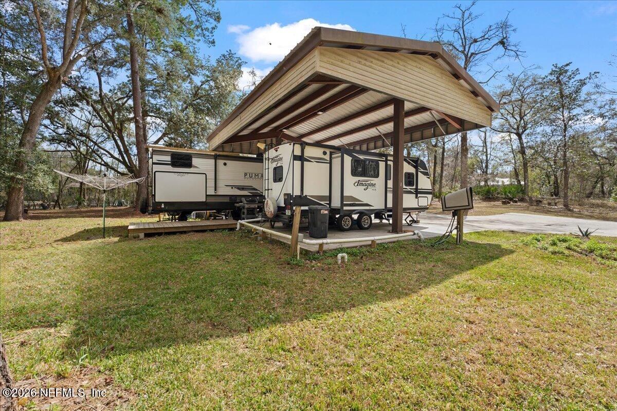 4229 Lazy Acres Road Middleburg, FL 32068 - Photo 17 of 41 a view of a house with swimming pool and sitting area