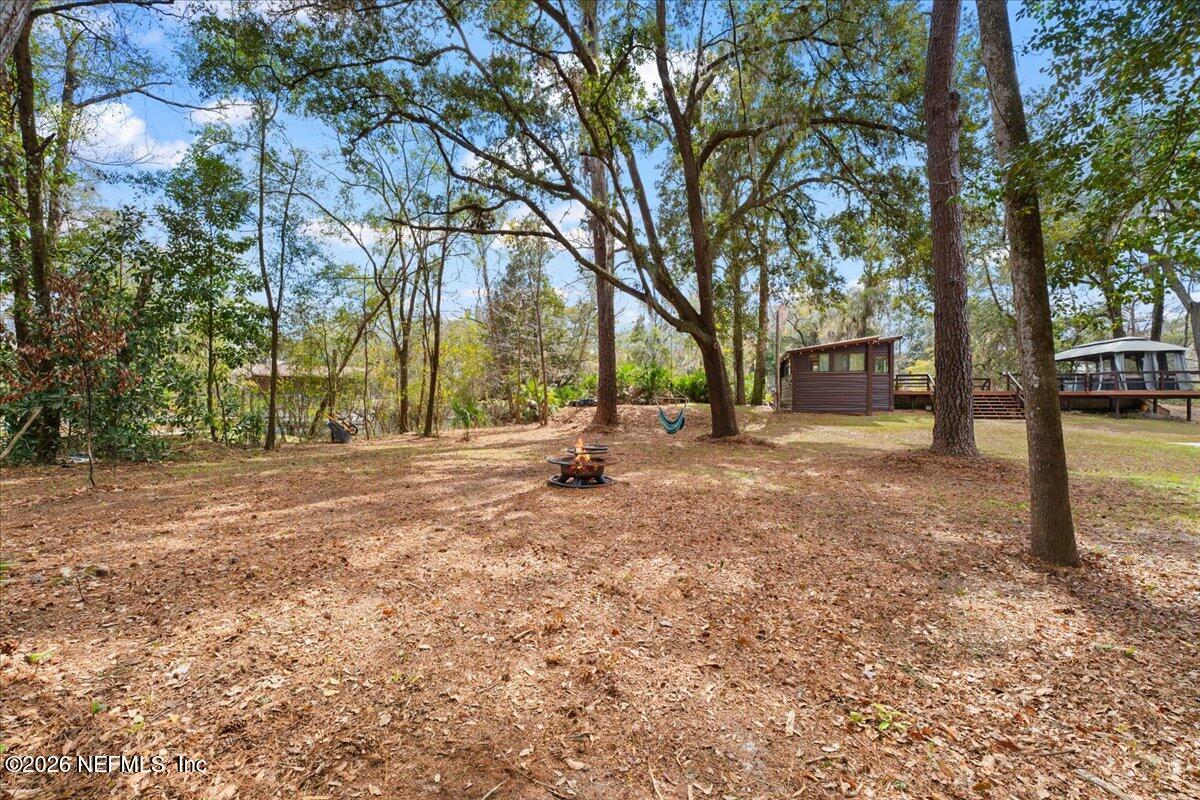 4229 Lazy Acres Road Middleburg, FL 32068 - Photo 25 of 41 a backyard of a house with trees and swing