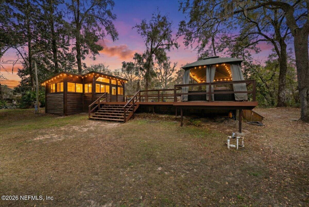 4229 Lazy Acres Road Middleburg, FL 32068 - Photo 4 of 41 a backyard of a house with barbeque oven and a fountain