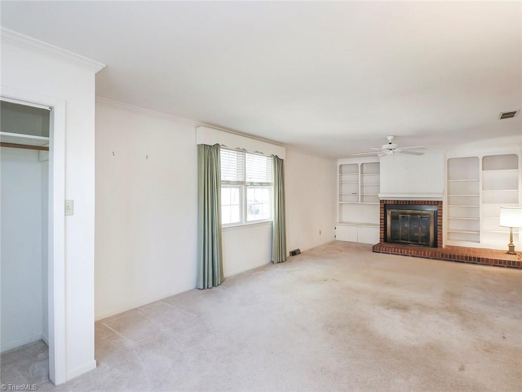 511 Edney Ridge Road Greensboro, NC 27408 - Photo 6 of 26 Living room with fireplace.