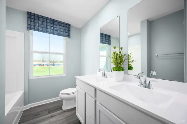 a bathroom with a sink a toilet and a window