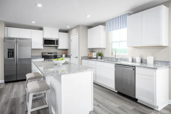 a kitchen with kitchen island granite countertop a sink cabinets and stainless steel appliances
