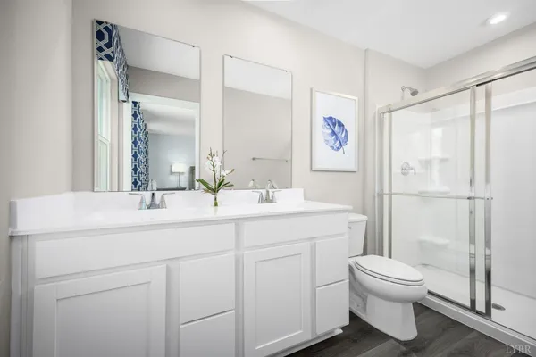a bathroom with a toilet a sink and a large mirror