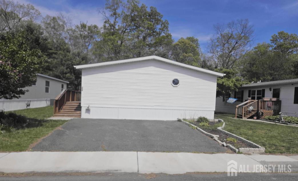 2110 Mays Landing Road, Unit 169 Millville, NJ 08332 - Photo 2 of 2 a house with trees in the background