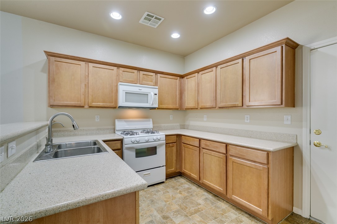 8937 Caledon Ridge Court Las Vegas, NV 89149 - Photo 23 of 43 A functional kitchen boasts ample cabinetry and essential appliances for everyday living.