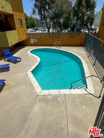 a view of a tennis ground with large trees